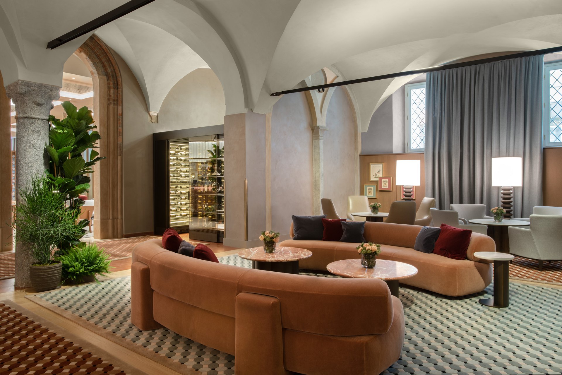 The vaulted lounge of the Four Seasons Hotel Milano, with curved velvet sofas under the old convent arches