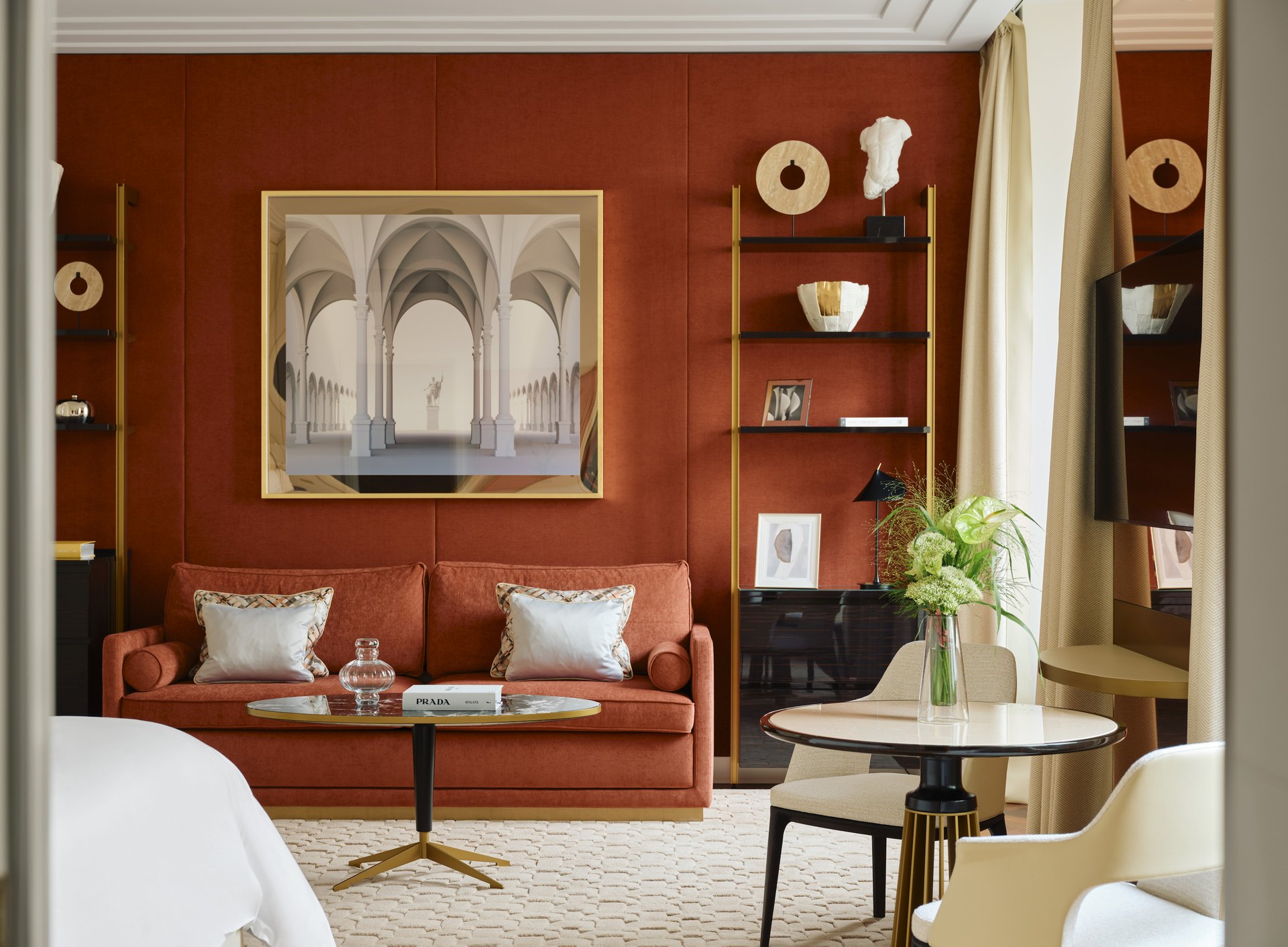 A suite at the Four Seasons Hotel Milano, with terracotta walls, a sofa and an architectural print